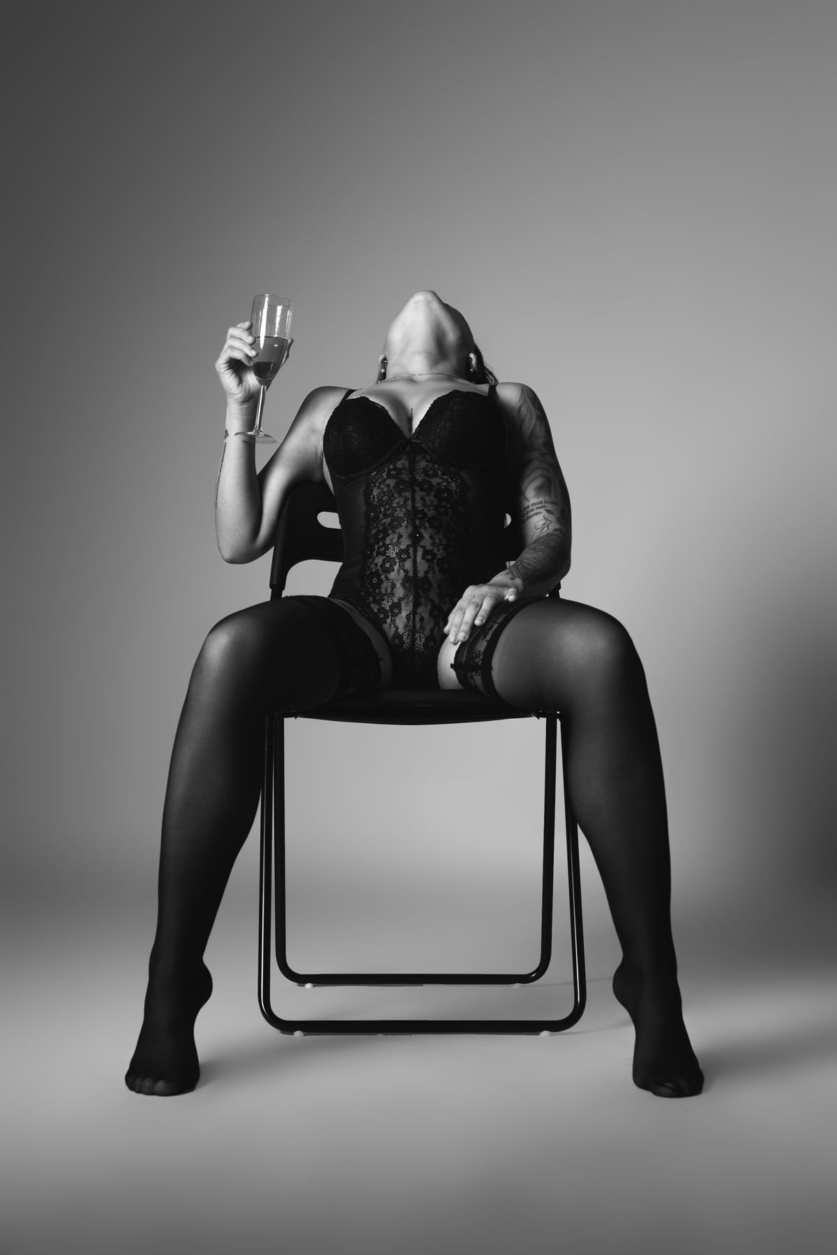 Portrait noir et blanc en studio, modèle assise sur une chaise